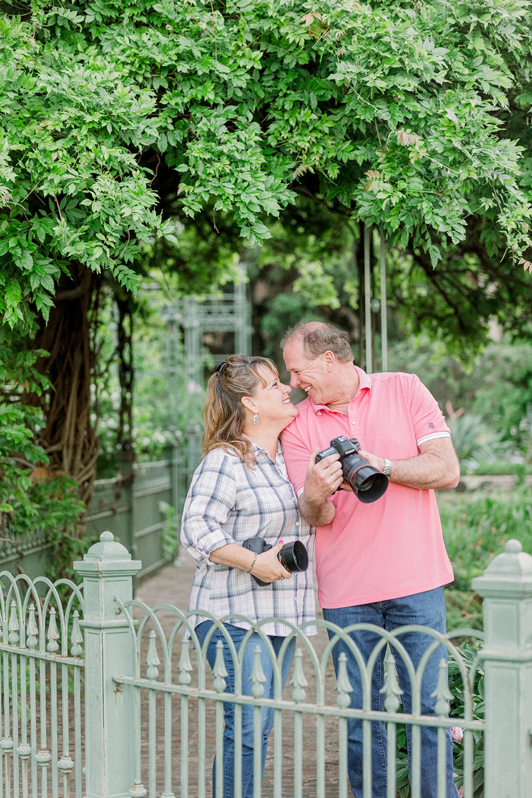 blog intro-photography couple smiling at each other holding cameras