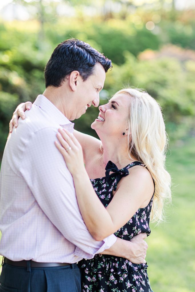 engaged couple embracing in Gilcrease garden