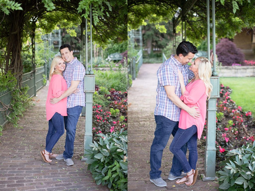 Couple leaning against arch at Gilcrease Museum Tulsa engagement