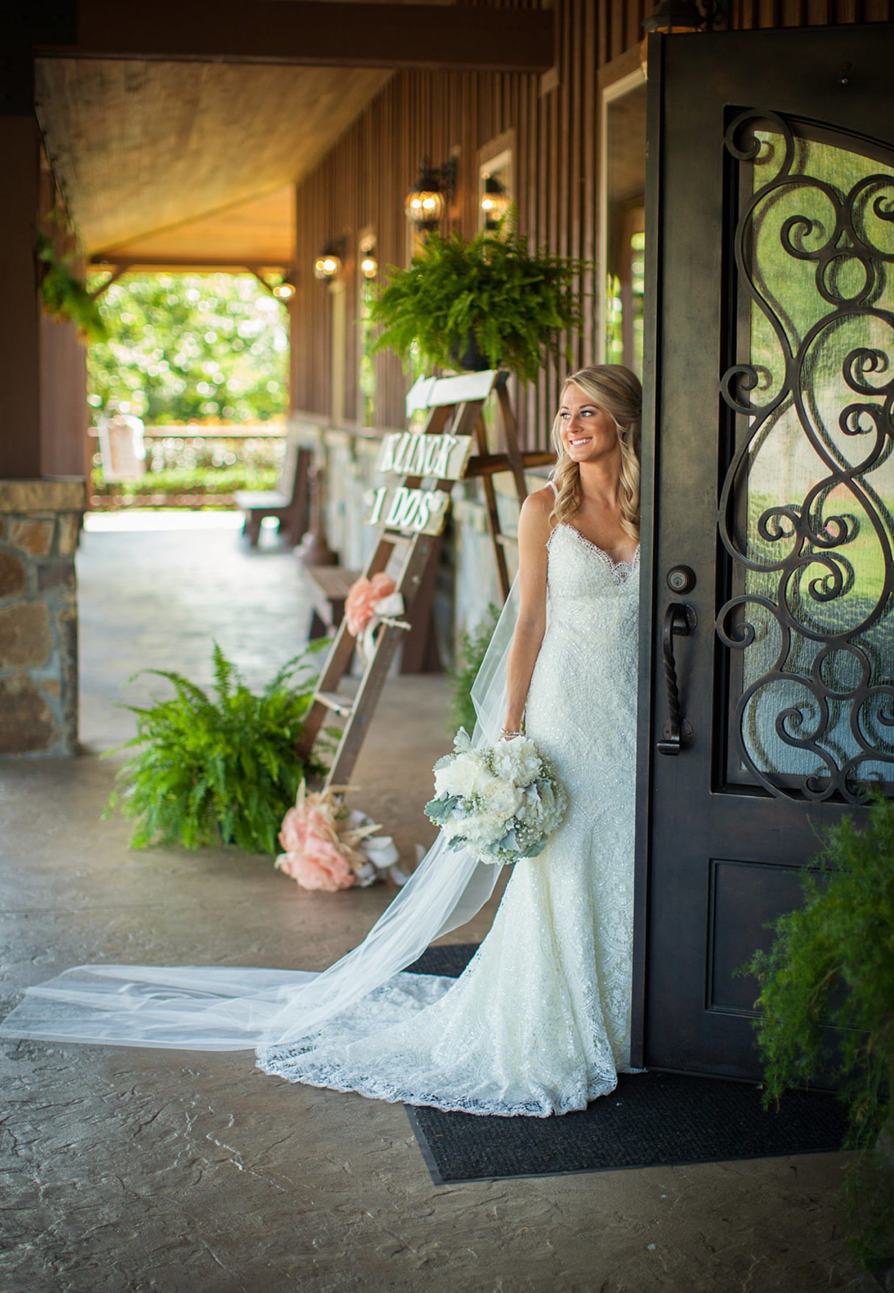 Bride standing in French doors at The Springs Event Center Wedding