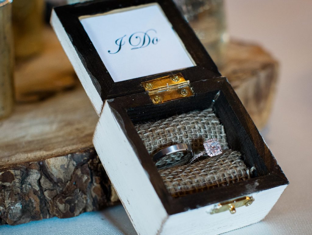 Bride and groom wedding rings in I DO ring box