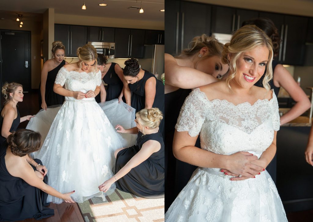 Bridesmaids helping bride into dress