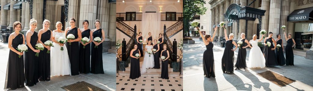 Bride standing with bridesmaids in black at The Mayo Hotel Tulsa wedding
