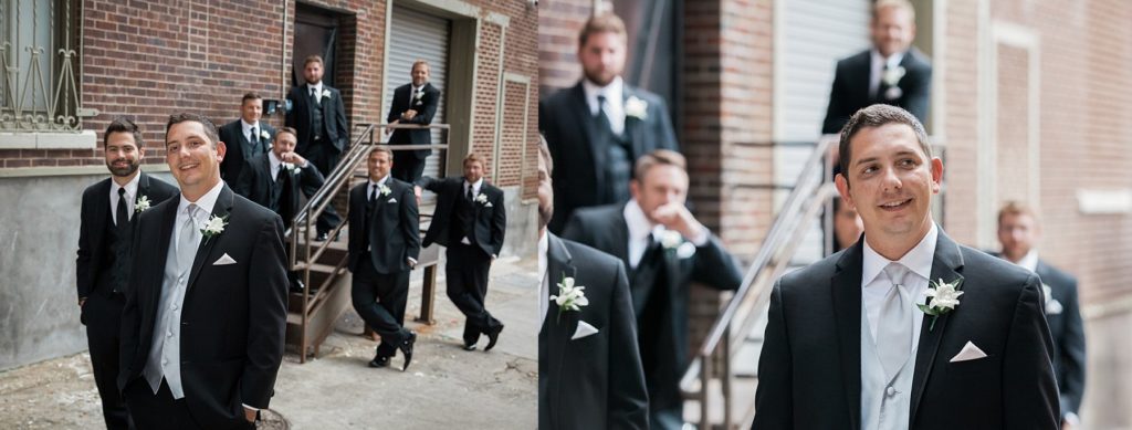 Groom and groomsmen standing in alley outside the Mayo Hotel