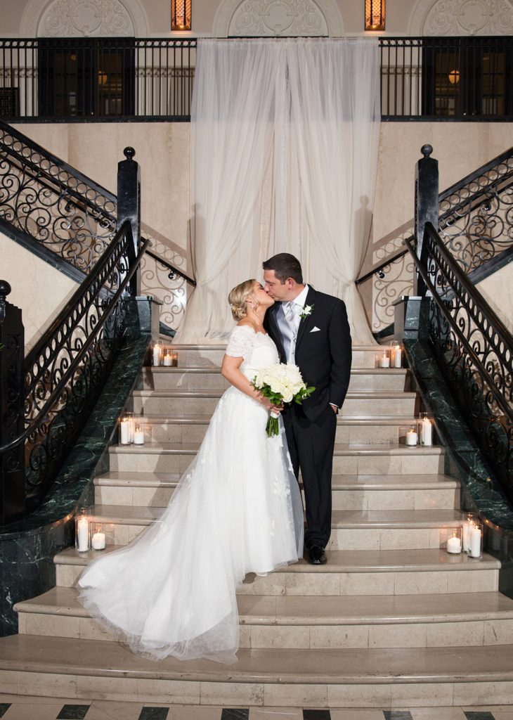 Bride and groom kiss on stairs at the Mayo